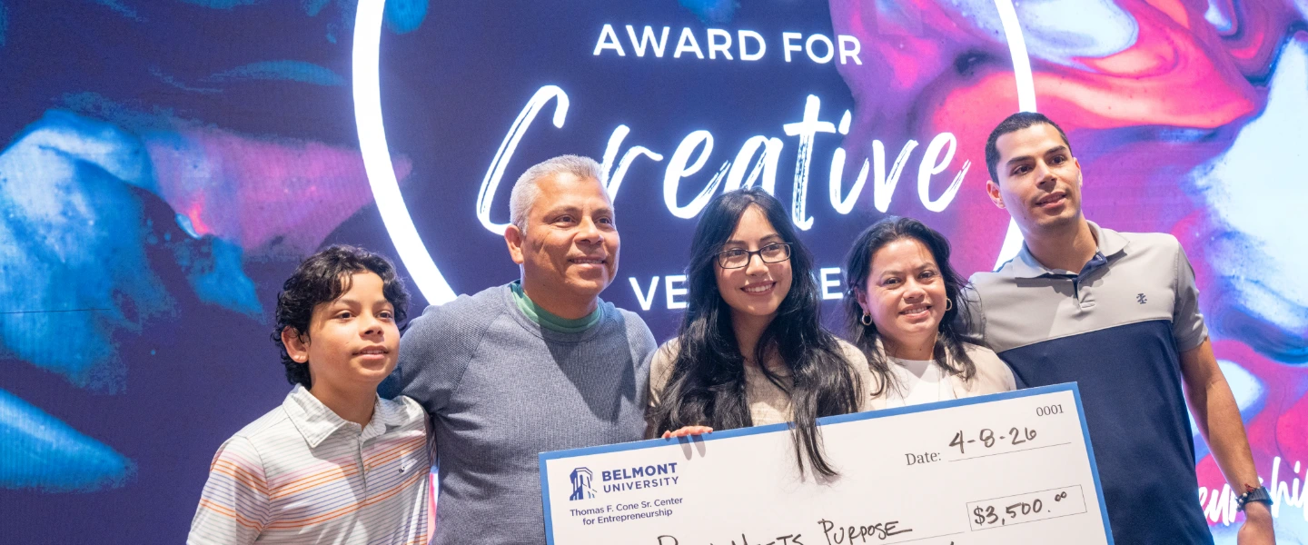 Student with family holding big check