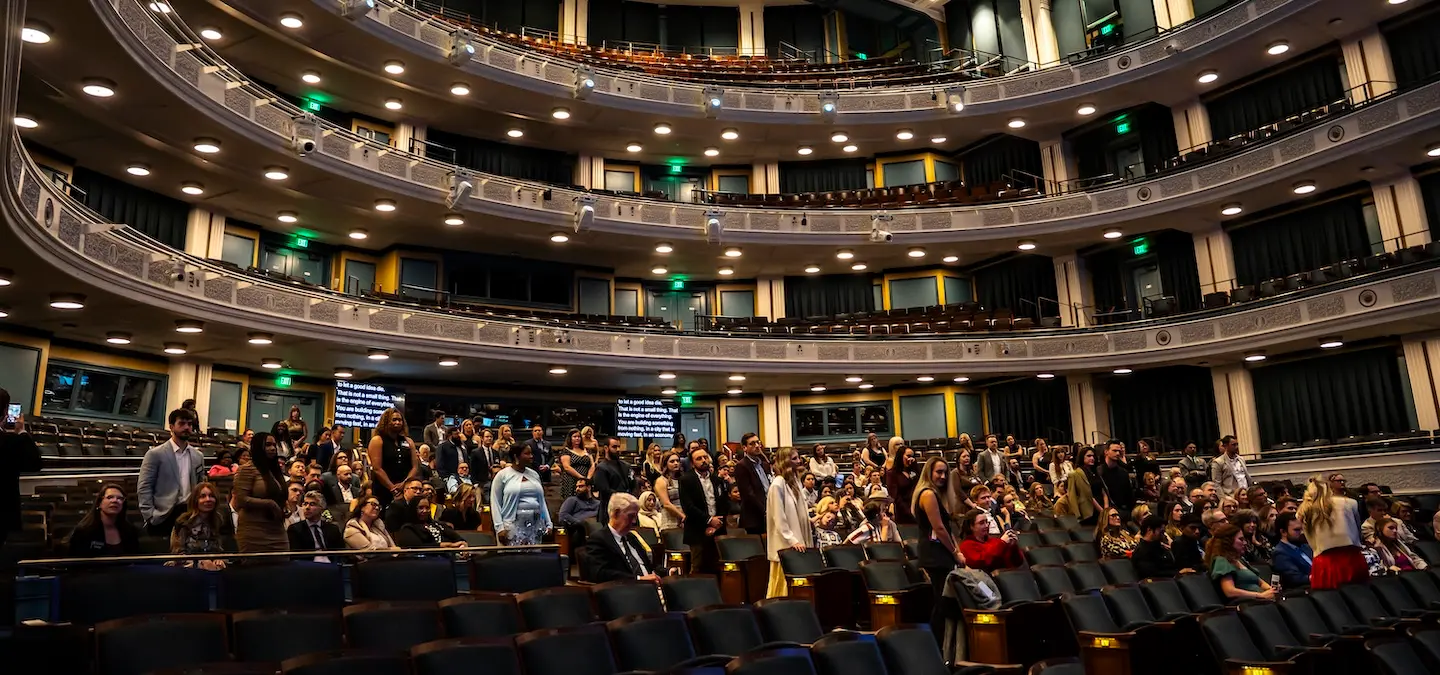 Alumni, staff and students in Fisher Center auditorium