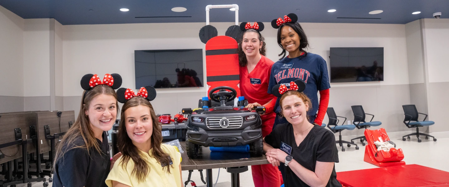 Students smiling with their modified car