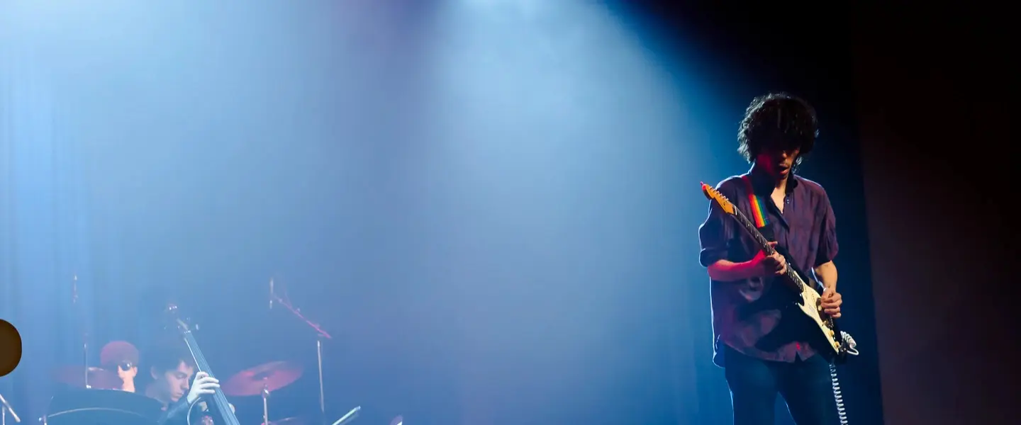 Commercial Guitar student playing on stage
