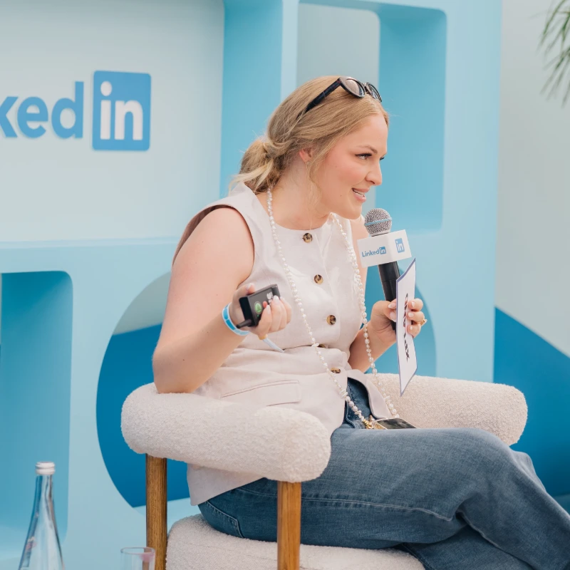 Abby speaking onstage at an event