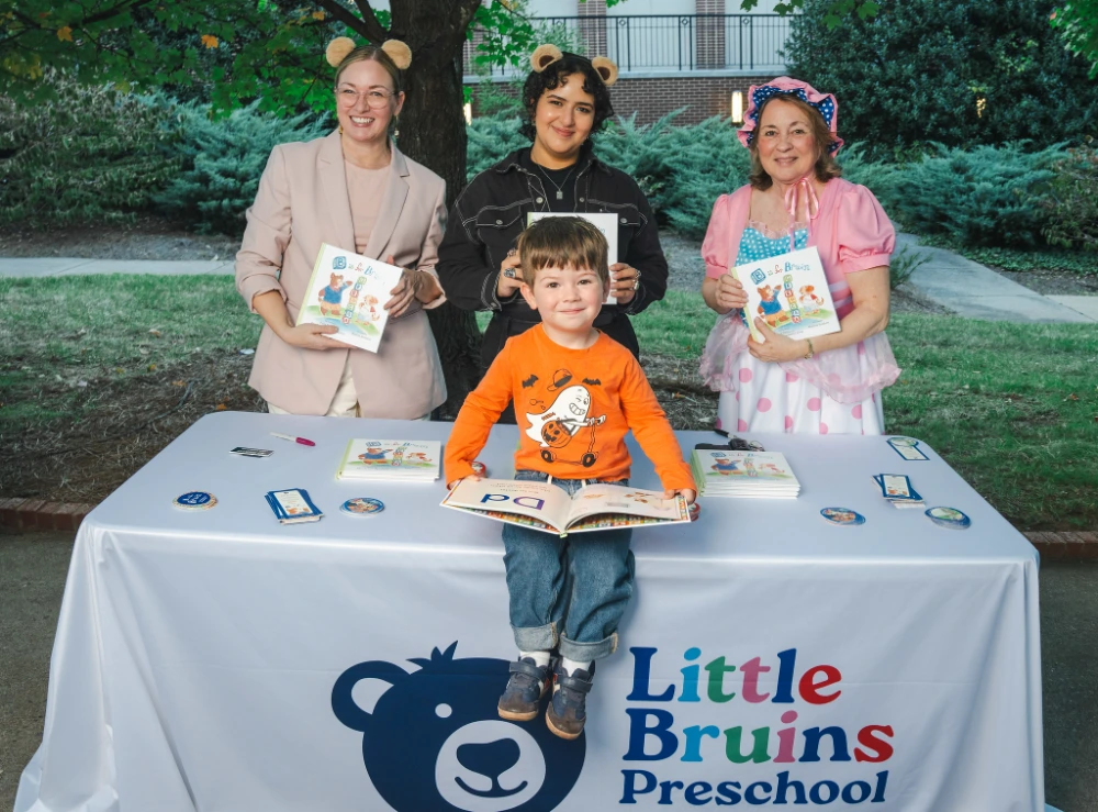 Young boy sitting on table with the book