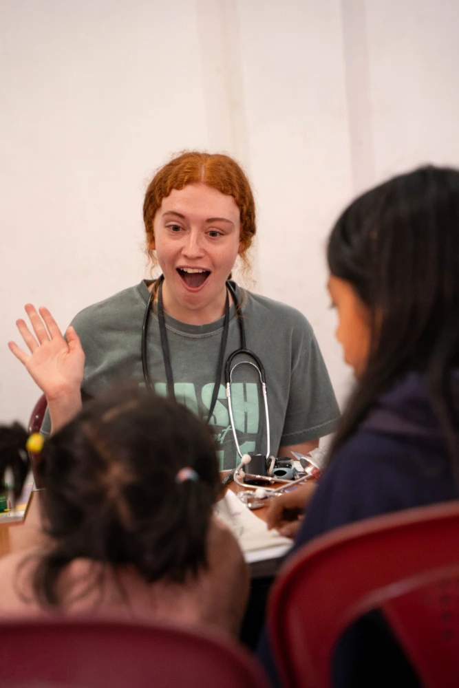 Students playing with children during clinic hours