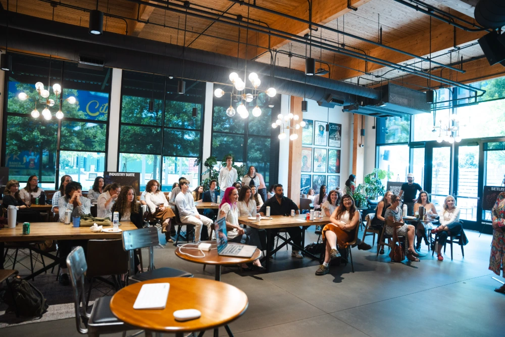 A group of students gather in a modern office space
