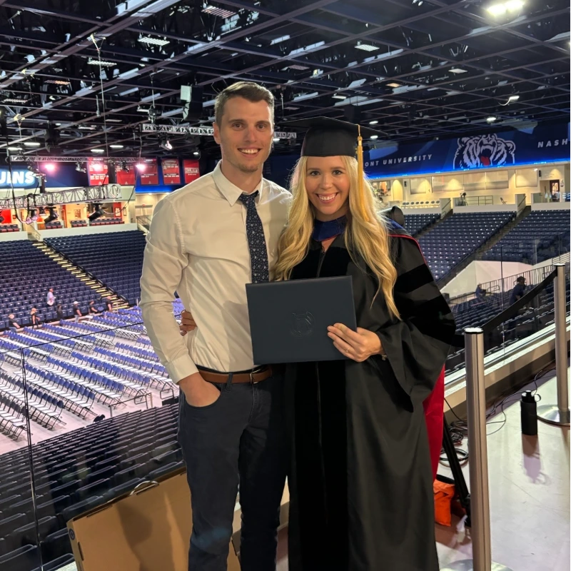 Delaney and her husband at her graduation in the Belmont arena