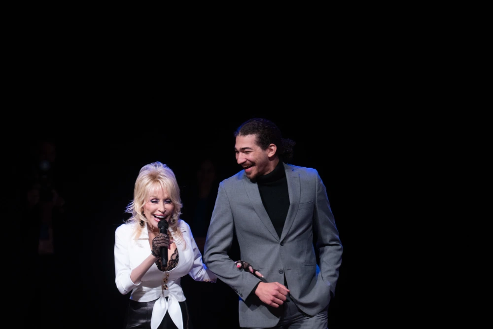 Dolly and Student on Stage at Musical Announcement