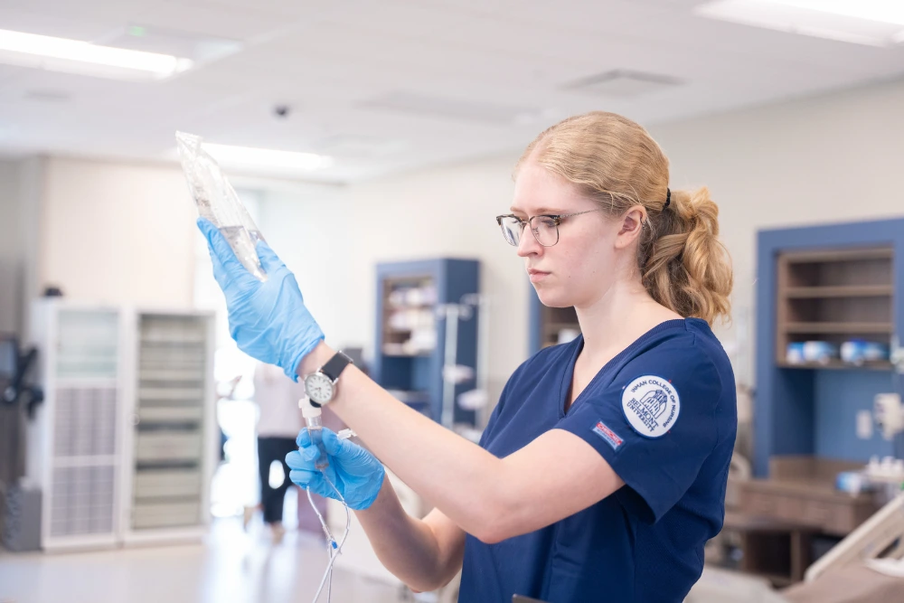Nursing student with IV bag