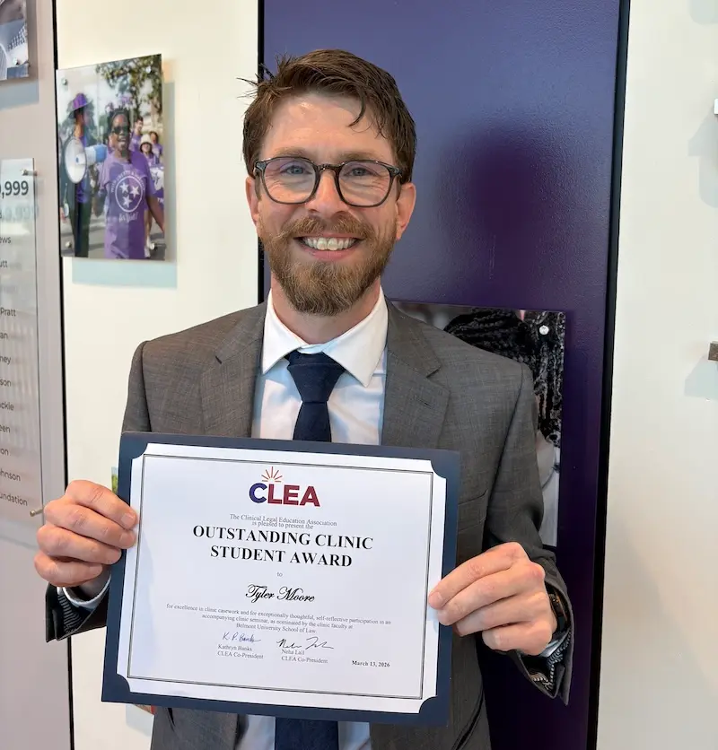 Tyler Moore holding certificate