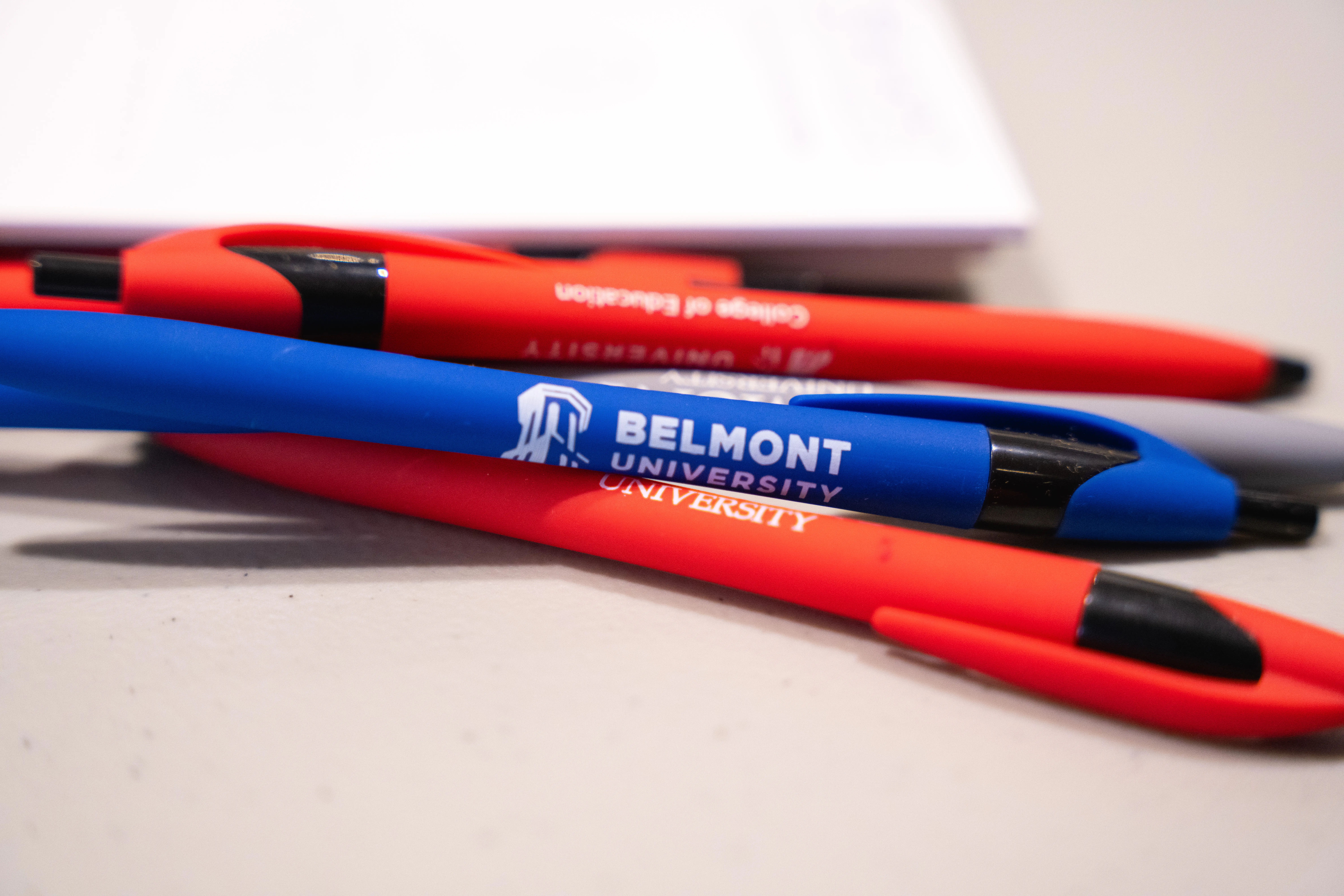 blue and red pens with Belmont University written on them