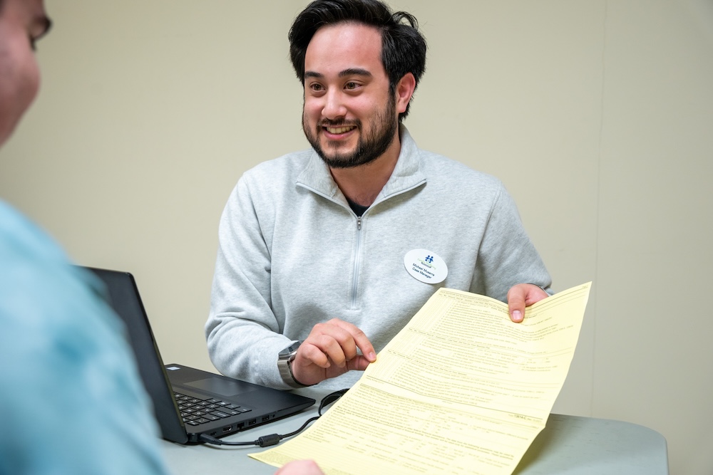 Student helping someone with a tax document
