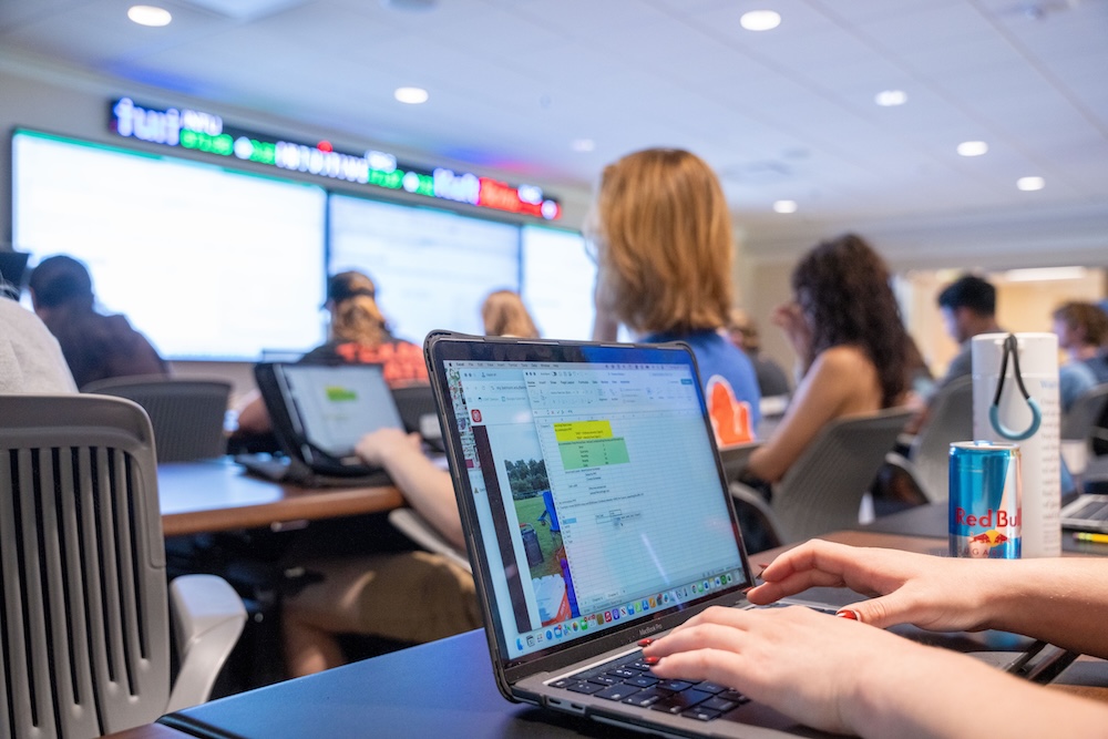 open laptop with finance class in background