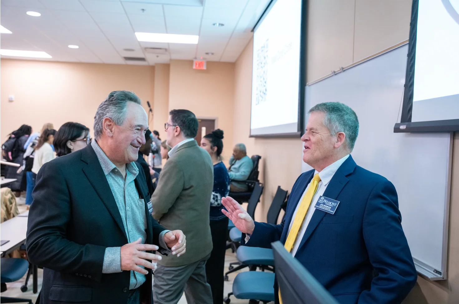 members of the panel socializing afterwards