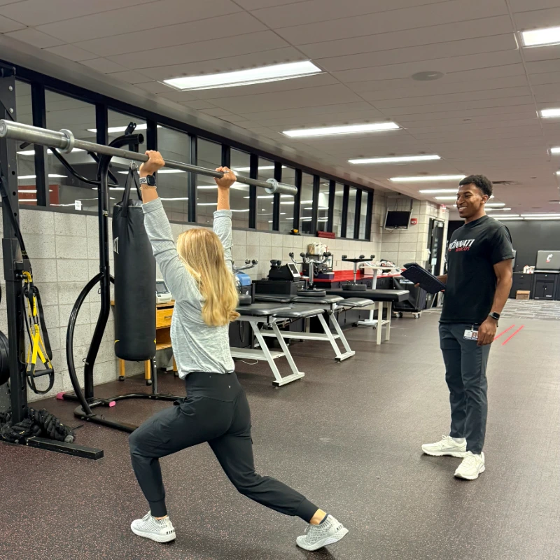 William working with another student on proper use of barbells during PT appointments