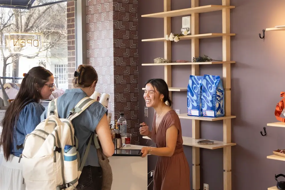 Catherine Norris serving coffee to customers
