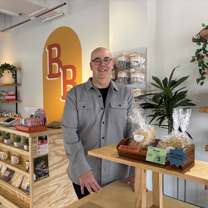 Matt Burhart next to products in Bruin Shop