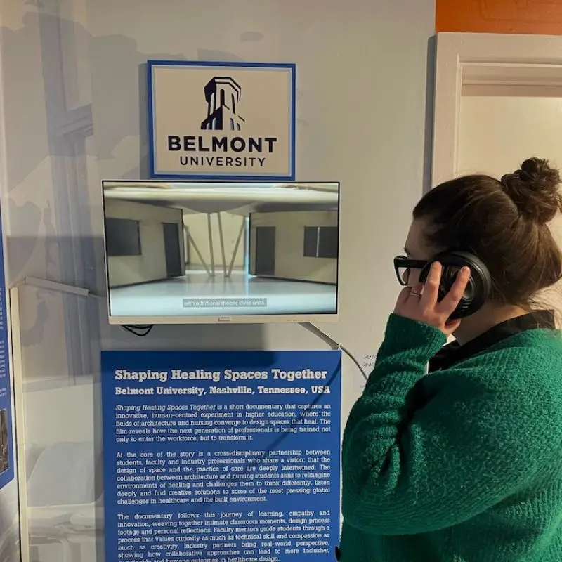 A museum patron watches the Shaping Healing Spaces documentary at the museum