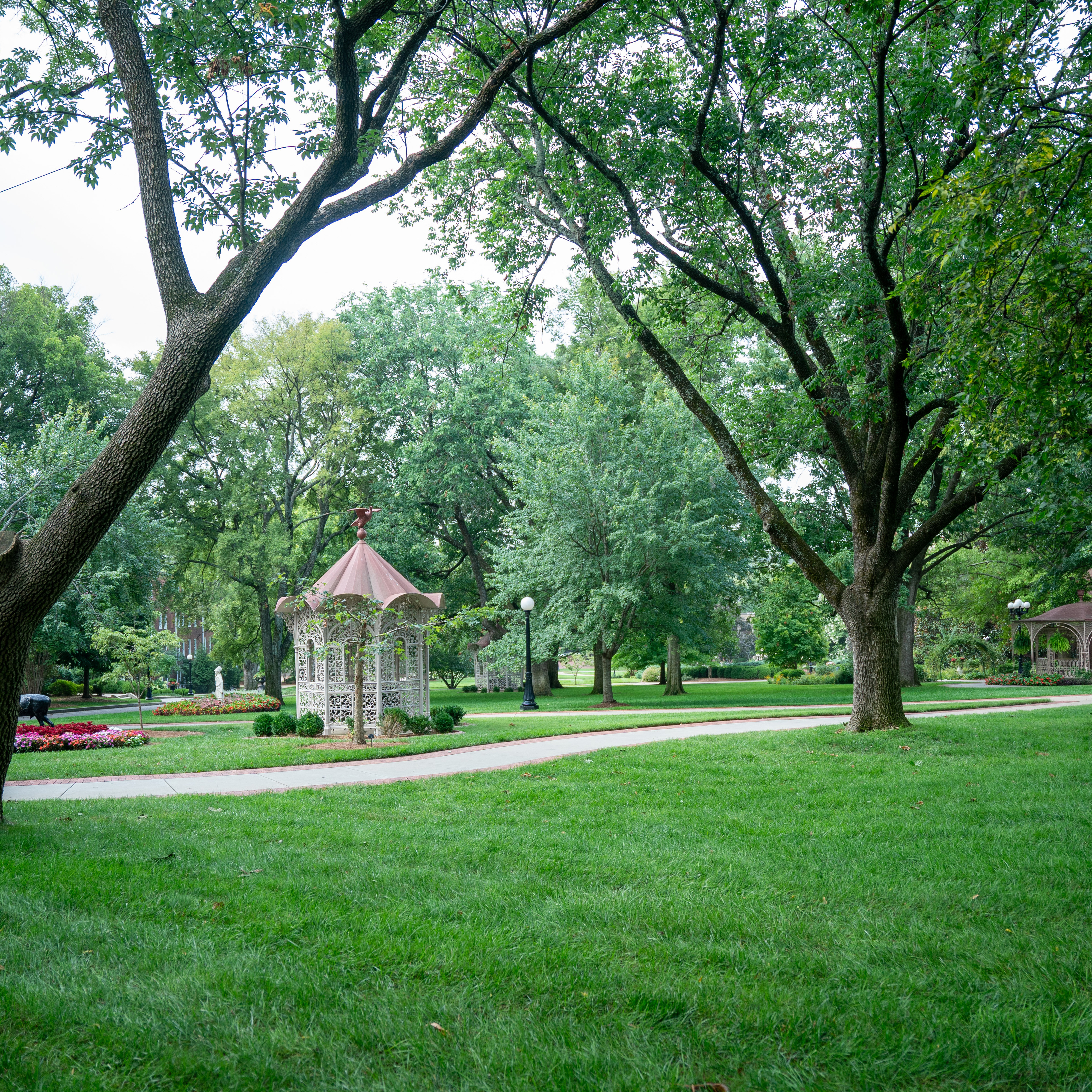 A view of the quad and various gazebos, statues, and trees 