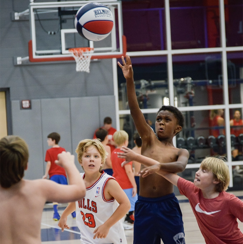 Young boys playing basketball during Belmont's basketball summer camp