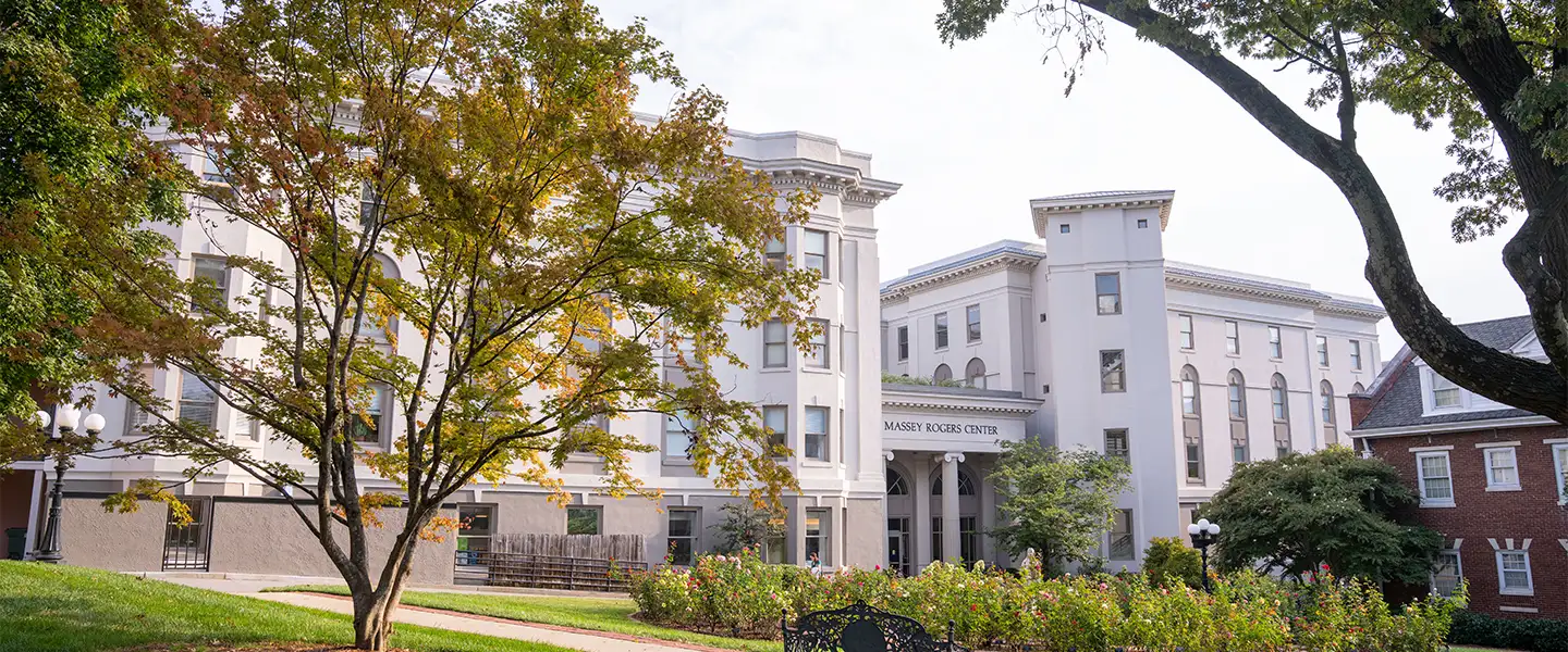 The exterior of Barbara Rogers Massey Center at Belmont University, showcasing its elegant architecture and landscaping, with a focus on the entrance and surrounding greenery. 