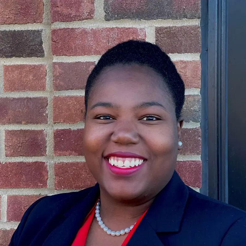 Portrait of Jessica Butler with a brick wall behind her