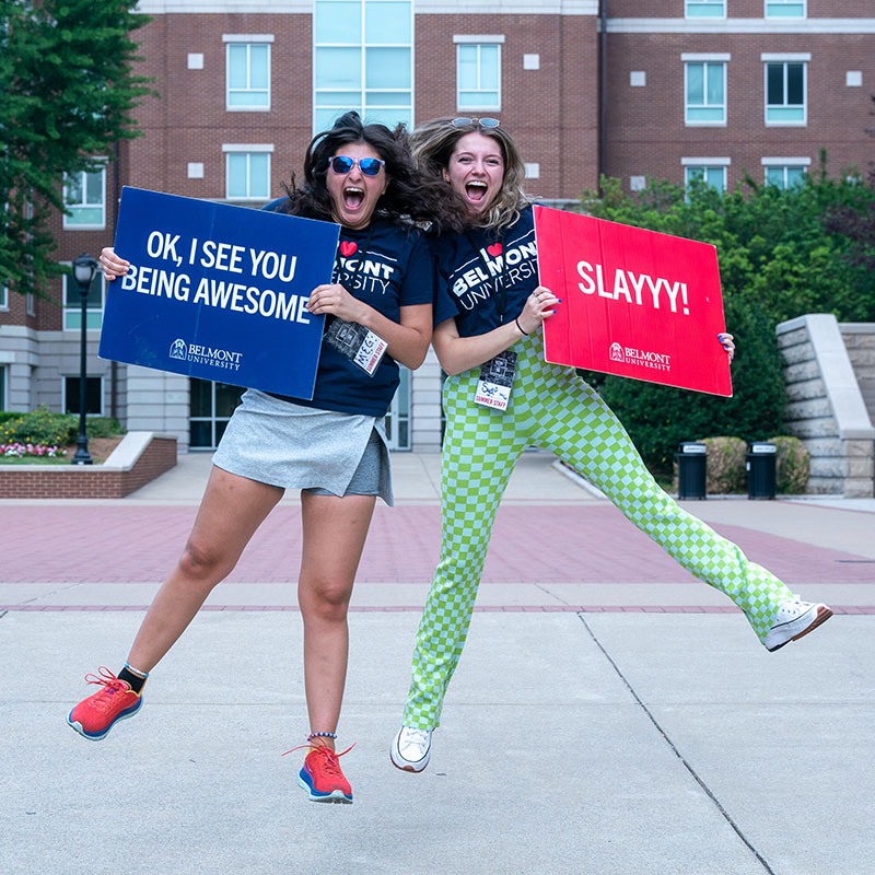 Students cheering with signs at Orientation