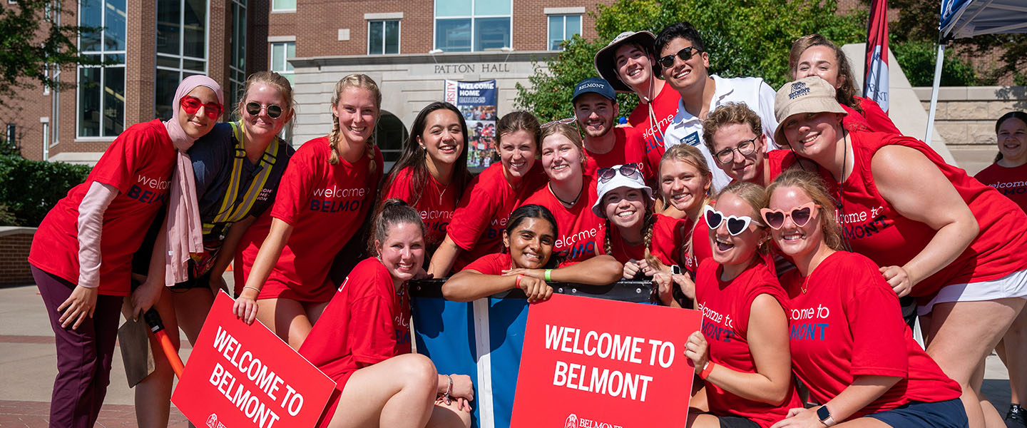 Tower Team Leaders posing for a photo with two welcome to Belmont signs