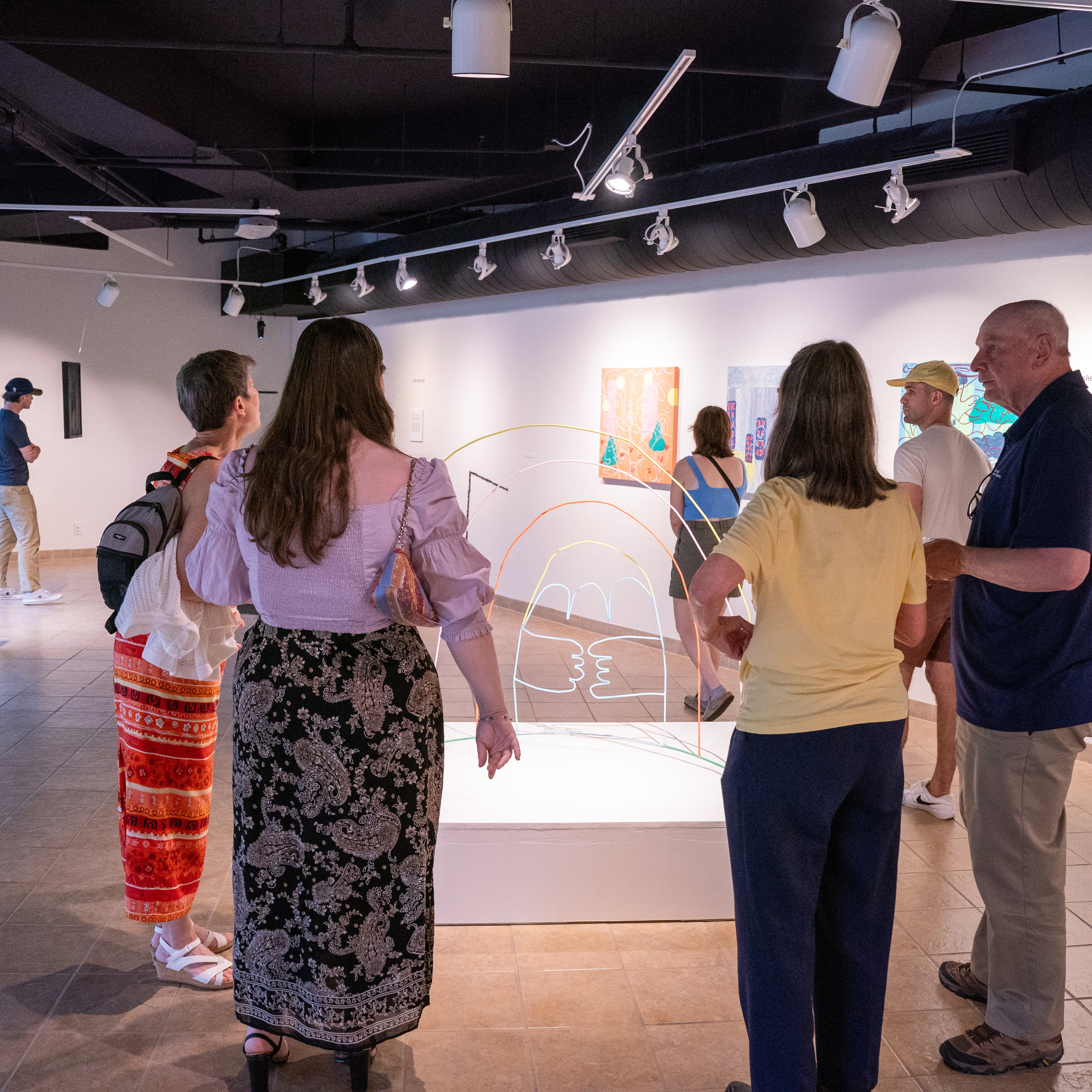 people in gallery looking at art