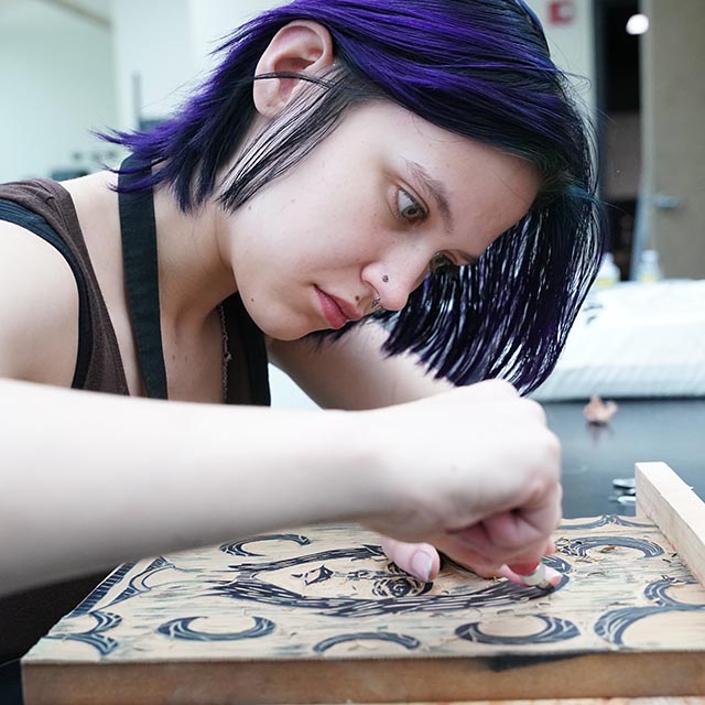 Teen working on carving printmaking project