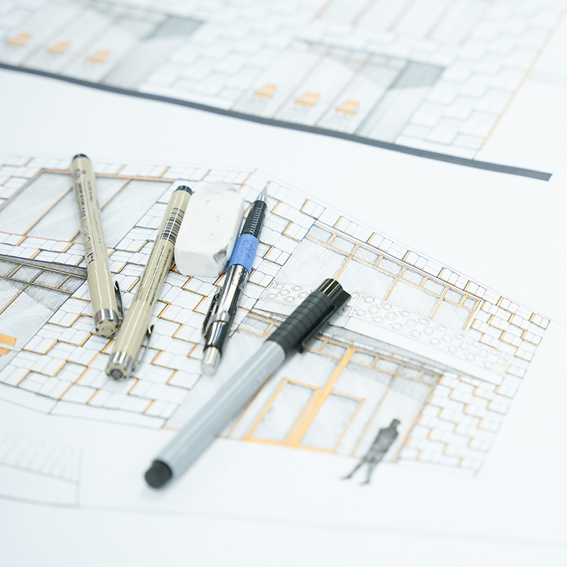 architectural rendering with pens, pencils, and an eraser