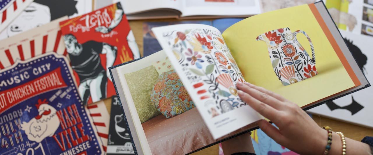 Close up of someone flipping through illustration book